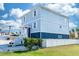 Beautiful two-story home with a white picket fence, blue exterior, and a lush green lawn at 435 Jessamine Ave, New Smyrna Beach, FL 32169