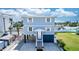 Charming elevated beach house with blue siding, white trim, and well-manicured lawn on a sunny day at 435 Jessamine Ave, New Smyrna Beach, FL 32169