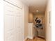 Hallway view with wood-look floors, closet doors, stairway, and artwork hanging on the neutral colored wall at 435 Jessamine Ave, New Smyrna Beach, FL 32169