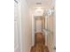 Bright hallway with wood floors, closet organizers, and white trim at 435 Jessamine Ave, New Smyrna Beach, FL 32169