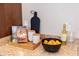 Countertop decorated with cookbook, lemons in a bowl, wine bottle, cutting board, jars and other kitchen items at 435 Jessamine Ave, New Smyrna Beach, FL 32169