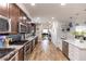 Spacious kitchen with stainless appliances, granite counters, breakfast bar, blue backsplash, and hardwood flooring at 435 Jessamine Ave, New Smyrna Beach, FL 32169