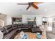 Inviting living room with a leather sectional sofa, wood floors, and open layout, flowing to the kitchen at 435 Jessamine Ave, New Smyrna Beach, FL 32169