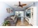 Coastal living room with a gray sofa, a large television, and a sliding glass door leading to a balcony at 435 Jessamine Ave, New Smyrna Beach, FL 32169