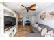 Cozy living room featuring a large TV, a comfortable gray sofa, a piano and a mini bar at 435 Jessamine Ave, New Smyrna Beach, FL 32169