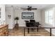 Elegant living room featuring wood floors, a baby grand piano, and neutral décor with large windows at 435 Jessamine Ave, New Smyrna Beach, FL 32169