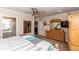 Well-lit main bedroom featuring a ceiling fan, dresser, and ensuite bathroom at 435 Jessamine Ave, New Smyrna Beach, FL 32169