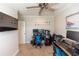 Home office featuring dual workstations, comfortable chairs, ceiling fan, and ample natural light at 435 Jessamine Ave, New Smyrna Beach, FL 32169