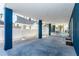 Spacious outdoor patio with blue pillars and a white fence, providing a perfect blend of style and privacy at 435 Jessamine Ave, New Smyrna Beach, FL 32169