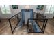 Stylish staircase with modern metal railings leading to a 'Beach House' entrance and decorative chandelier at 435 Jessamine Ave, New Smyrna Beach, FL 32169