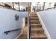 View of the staircase featuring wood treads and decorative metal railings, and pale blue wall paint at 435 Jessamine Ave, New Smyrna Beach, FL 32169