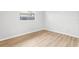 Cozy bedroom featuring hardwood floors, fresh paint, and ample natural light at 4425 Signal Hill Rd, Orlando, FL 32808