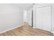 Bedroom with wood-look vinyl floors and a double closet for ample storage space at 4425 Signal Hill Rd, Orlando, FL 32808