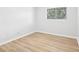 Bedroom featuring neutral paint, a window with security bars and wood-look vinyl floors at 4425 Signal Hill Rd, Orlando, FL 32808