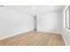 Bright bedroom with hardwood floors, fresh paint, and ample natural light at 4425 Signal Hill Rd, Orlando, FL 32808