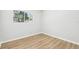 Bedroom featuring neutral paint, a window and wood-look vinyl floors at 4425 Signal Hill Rd, Orlando, FL 32808