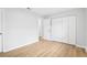 Bright bedroom with hardwood floors, fresh paint, and a spacious closet at 4425 Signal Hill Rd, Orlando, FL 32808