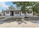 Charming single-story home with a beautifully landscaped front yard and mature tree at 4425 Signal Hill Rd, Orlando, FL 32808