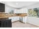 Well-lit kitchen featuring modern appliances, white cabinetry, and ample counter space at 4425 Signal Hill Rd, Orlando, FL 32808