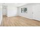 Bright living room featuring hardwood floors, fresh paint, and a large window at 4425 Signal Hill Rd, Orlando, FL 32808