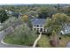 An aerial view of a charming home with a green lawn surrounded by trees at 450 Lakewood Dr, Winter Park, FL 32789
