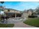 Backyard features a large pool with a fountain, an outdoor kitchen, and an entertainment area at 450 Lakewood Dr, Winter Park, FL 32789