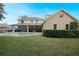 Large backyard featuring a beautiful swimming pool, covered patio, and landscaped yard at 450 Lakewood Dr, Winter Park, FL 32789