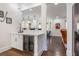 Bright bar area with wine fridge, quartz countertops, and view into the kitchen and living spaces at 450 Lakewood Dr, Winter Park, FL 32789