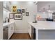 Bar area featuring white cabinetry, quartz countertop, wine cooler, and golf-themed decor at 450 Lakewood Dr, Winter Park, FL 32789