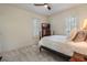 Bedroom featuring neutral carpet, plantation shutters, and a comfortable bed with a dark wood frame at 450 Lakewood Dr, Winter Park, FL 32789