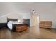 Spacious bedroom featuring a dark wood bed set, hardwood floors, and a comfortable brown leather sofa at 450 Lakewood Dr, Winter Park, FL 32789