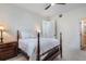 Bedroom with wood-framed bed, nightstand, and white walls with a ceiling fan at 450 Lakewood Dr, Winter Park, FL 32789