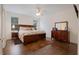 Bedroom featuring hardwood floors, a ceiling fan, and large windows for ample natural light at 450 Lakewood Dr, Winter Park, FL 32789