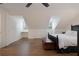 Bright bedroom with angled ceilings, a wood storage chest, and hardwood floors at 450 Lakewood Dr, Winter Park, FL 32789