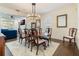 Elegant dining room with a hardwood table, seating for six, and a modern chandelier at 450 Lakewood Dr, Winter Park, FL 32789