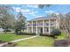 Elegant two-story home with well-maintained landscaping and a inviting walkway to the covered front porch at 450 Lakewood Dr, Winter Park, FL 32789