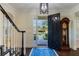 Inviting home foyer with staircase, a striking front door, and views of the landscaped yard at 450 Lakewood Dr, Winter Park, FL 32789