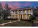 Stately two-story home featuring columns, a landscaped yard, and a brick walkway at 450 Lakewood Dr, Winter Park, FL 32789