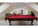Bright game room with a pool table, lounge area, and modern lighting fixtures at 450 Lakewood Dr, Winter Park, FL 32789