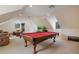 Spacious game room featuring a pool table, comfortable seating, and natural light at 450 Lakewood Dr, Winter Park, FL 32789