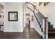 Elegant hallway with staircase, dark wood floors and white trim at 450 Lakewood Dr, Winter Park, FL 32789