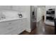 Modern kitchen featuring sleek white cabinetry, premium appliances, and elegant finishes at 450 Lakewood Dr, Winter Park, FL 32789