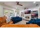 Cozy living room showcasing comfortable seating, a fireplace with built-ins, and access to outdoor spaces at 450 Lakewood Dr, Winter Park, FL 32789