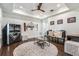 A unique living room with a ceiling fan, a jukebox, and a round patterned rug at 450 Lakewood Dr, Winter Park, FL 32789