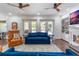Bright living room featuring comfortable seating, a fireplace, and access to outdoor spaces at 450 Lakewood Dr, Winter Park, FL 32789
