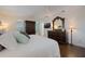 A stylish main bedroom with hardwood floors, ceiling fan, and a comfortable king-size bed at 450 Lakewood Dr, Winter Park, FL 32789