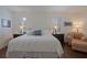 Bright main bedroom featuring an inviting king bed, plantation shutters, and a cozy seating area at 450 Lakewood Dr, Winter Park, FL 32789