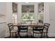 Breakfast nook featuring built-in seating, a dining table, and large windows with a view of the backyard at 450 Lakewood Dr, Winter Park, FL 32789
