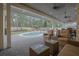 Charming patio with outdoor seating that overlooks the pool and backyard at 450 Lakewood Dr, Winter Park, FL 32789