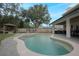 Inviting pool with beautiful stone design, gazebo, and outdoor kitchen perfect for entertaining at 450 Lakewood Dr, Winter Park, FL 32789